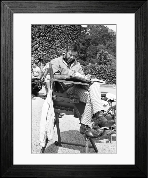 Framed Print : Director Jerry Lewis seen here reading the script whilst on location at Eastnor Castle