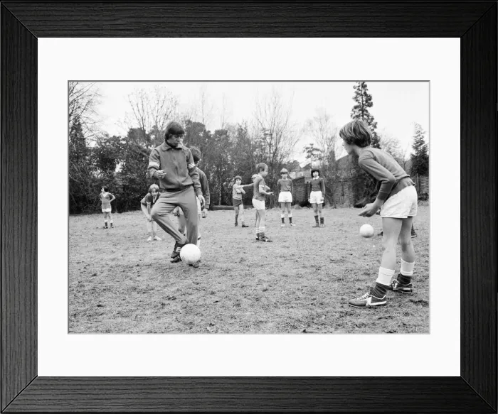 Framed Print : Queens Park Rangers footballer Don Masson coaching children to play football at the Our Framed Print : Queens Park Rangers footballer Don Masson coaching children to play football at the Our
