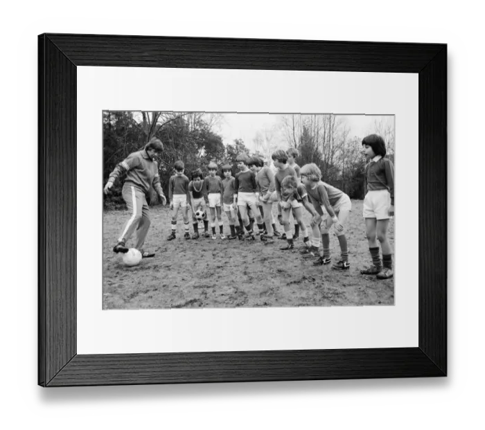 Framed Print : Queens Park Rangers footballer Don Masson coaching children to play football at the Our Framed Print : Queens Park Rangers footballer Don Masson coaching children to play football at the Our