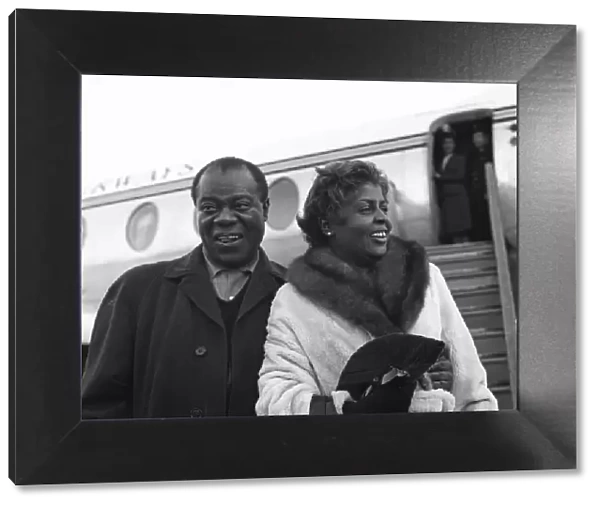 Louis Armstrong Pictured arriving at a London Airport with wife Lucille