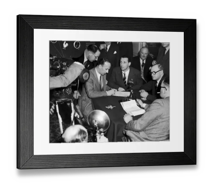 Framed Print : Footballer Tommy Lawton looks on as his new manager Jack Gibbons signs a contract after Framed Print : Footballer Tommy Lawton looks on as his new manager Jack Gibbons signs a contract after