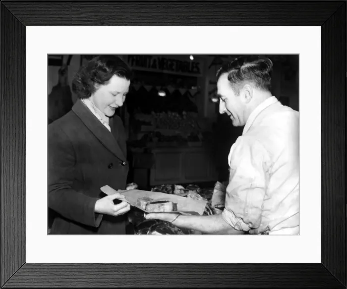 Framed Print : Post World War Two - Second World War - A woman collects her meat ration from a butcher