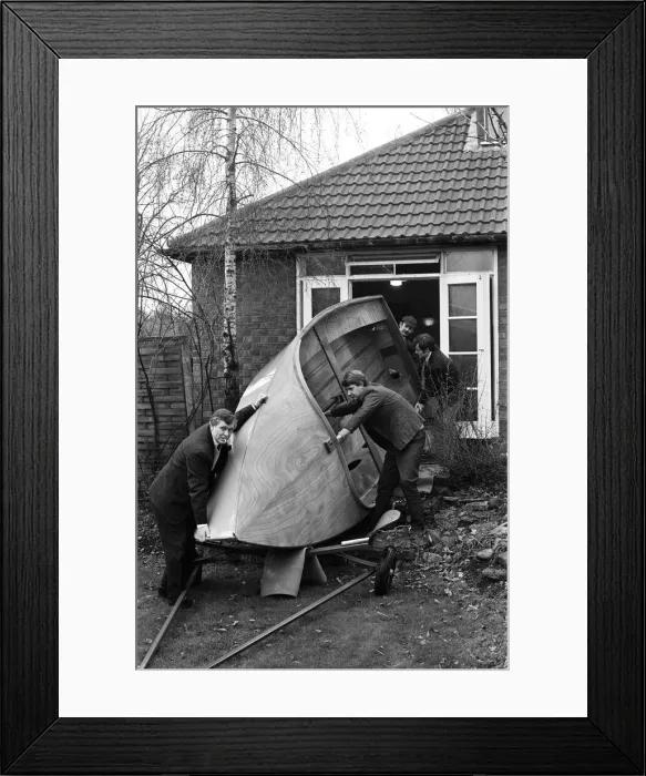 Framed Print : Mr Henry Fowler (left) enlists the aid of some friends to help him to take the boat out Framed Print : Mr Henry Fowler (left) enlists the aid of some friends to help him to take the boat out