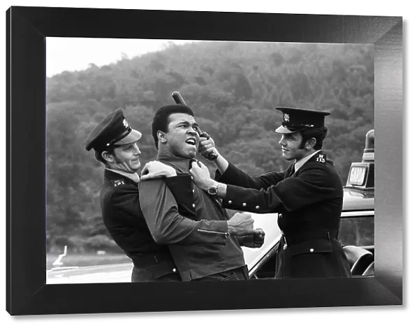 Muhammad Ali messing around with two policeman in Dublin prior to his fight with Alvin
