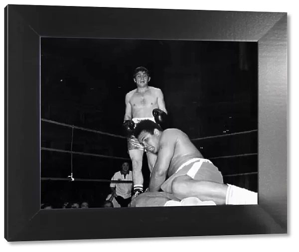 Muhammad Ali falls during his exhibition bout with Johnny Frankam at the Royal Albert