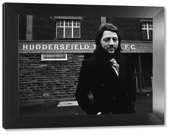 Huddersfield Town Frank Worthington with his Mustang car outside his team
