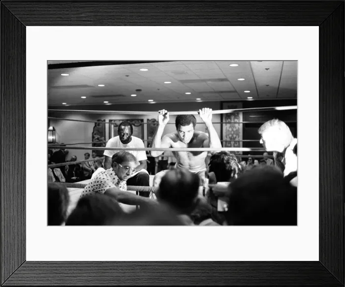Framed Print : Muhammad Ali takes a break from training to talk to the press ahead of his rematch with