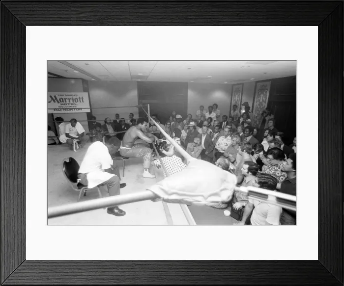 Framed Print : Muhammad Ali takes a break from training to talk to the press ahead of his rematch with