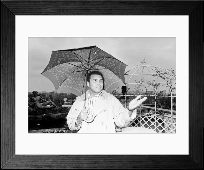 Framed Print : Muhammad Ali, former heavyweight boxing champion, stepping outside into the rain after a Framed Print : Muhammad Ali, former heavyweight boxing champion, stepping outside into the rain after a