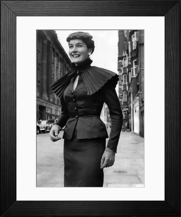 Framed Print : Clothing Fashion 1955: A black pure silk suit with small pleated detachable ruff cape of Framed Print : Clothing Fashion 1955: A black pure silk suit with small pleated detachable ruff cape of