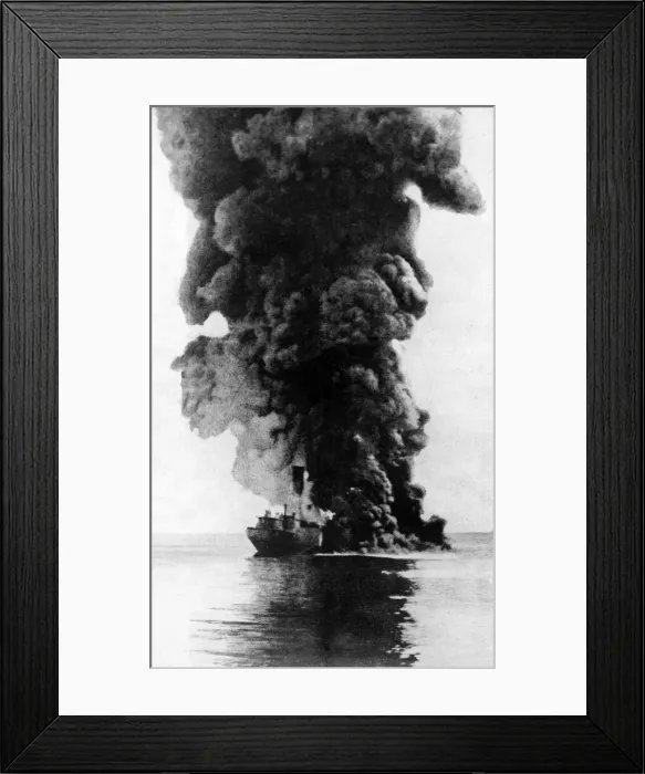Framed Print : A cargo steamer hit by a u-boat torpedo seen here burning and sinking by the bow Framed Print : A cargo steamer hit by a u-boat torpedo seen here burning and sinking by the bow