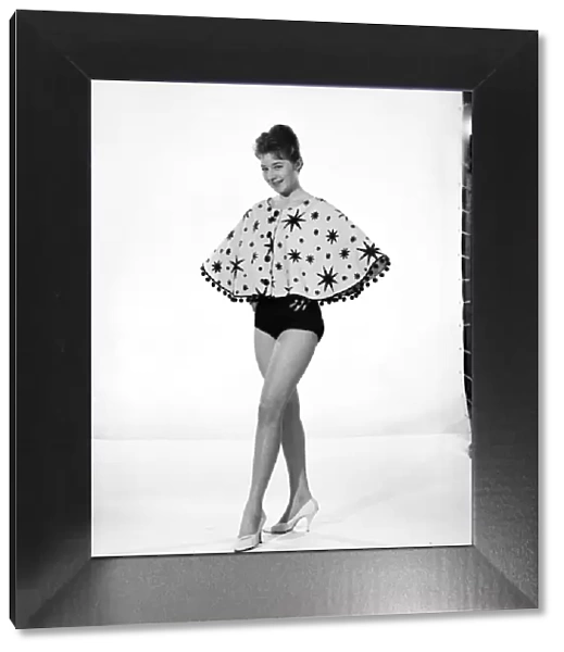 Clothing: Fashion: Capes: Woman wearing beach cape. Model: Maggie Duck. 1960 B1226-004