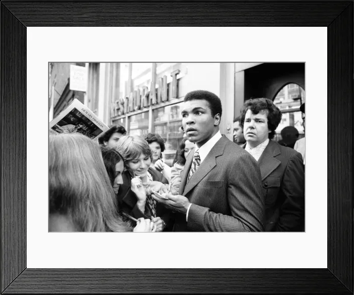 Framed Print : Muhammad Ali signing autographs ahead of his rematch with Joe Frazier. January 1974 Framed Print : Muhammad Ali signing autographs ahead of his rematch with Joe Frazier. January 1974