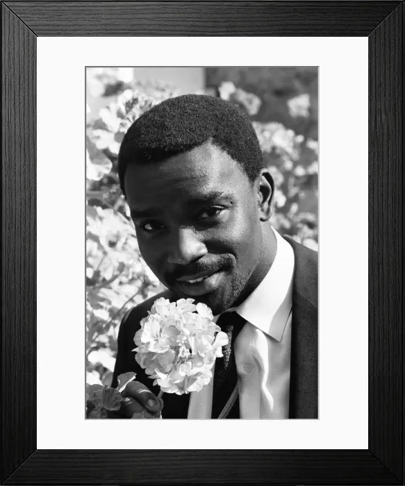 Framed Print : Laurie Cunningham poses for the camera with a flower Madrid Spain Framed Print : Laurie Cunningham poses for the camera with a flower Madrid Spain