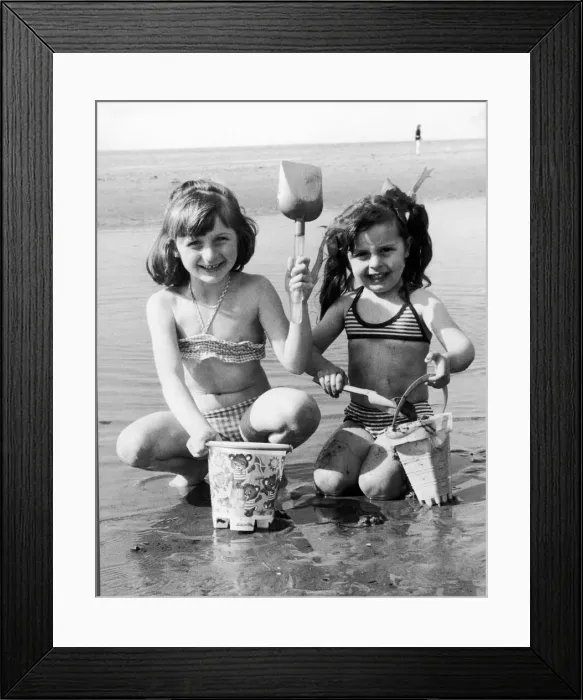 Framed Print : Wish you were here! Sharon-Anne Taney, left, and Maria Grant build a sand castle in Framed Print : Wish you were here! Sharon-Anne Taney, left, and Maria Grant build a sand castle in
