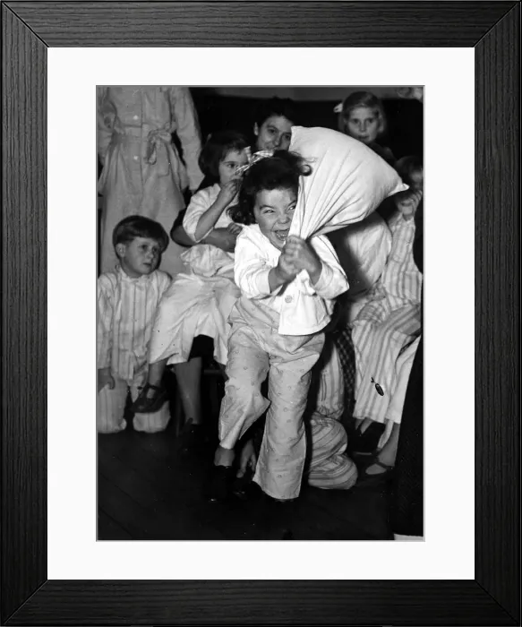 Framed Print : Children at bedtime have a pillow fight before bed. 23rd October 1950 Framed Print : Children at bedtime have a pillow fight before bed. 23rd October 1950
