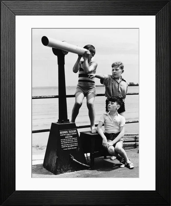Framed Print : Weymouth boys play on coast with telescope in the Dorset seaside town Framed Print : Weymouth boys play on coast with telescope in the Dorset seaside town