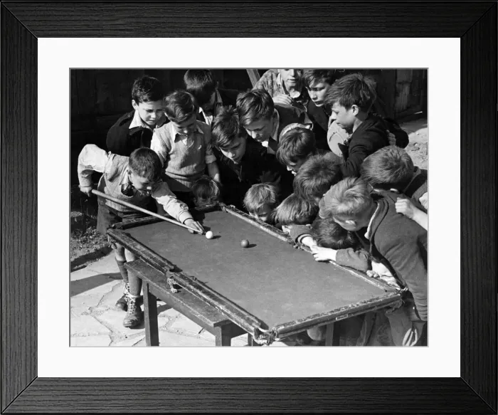 Framed Print : Children gather around a snooker table to play. Sixteen tousled heads bend over a rickety Framed Print : Children gather around a snooker table to play. Sixteen tousled heads bend over a rickety