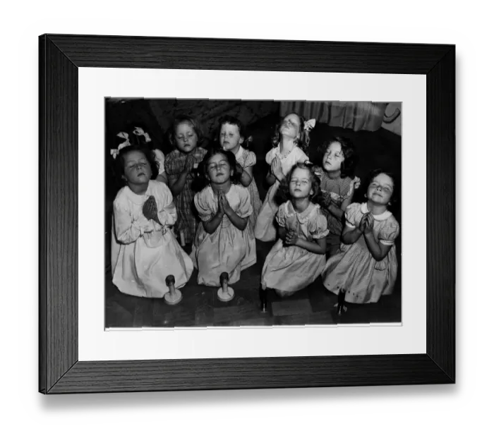 Framed Print : Children kneeling saying prayers. Circa 1940s
