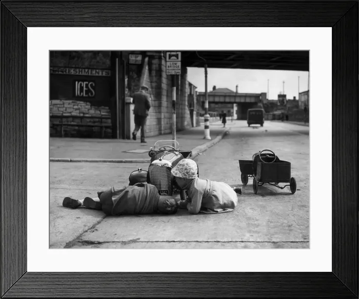 Framed Print : Two kids playing with their cars on the Barry Road, Cardiff. 16th June 1943