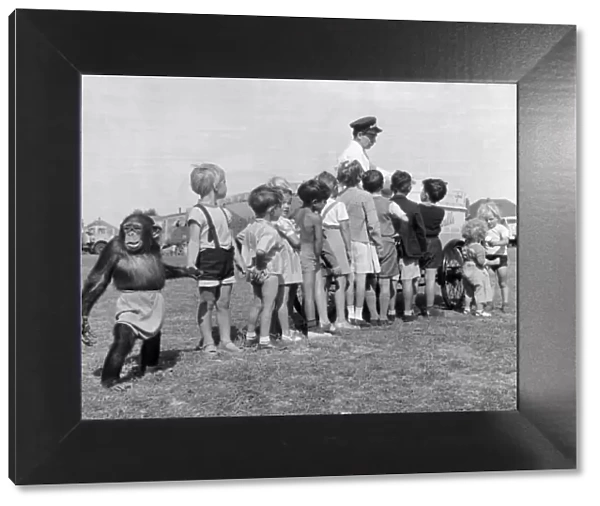 Children queue with their Chimpanzee friend for an ice cream at Billy Smart Circus 6th