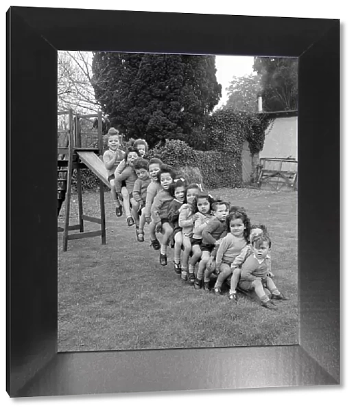 Children Line up on a slide. Circa 1949