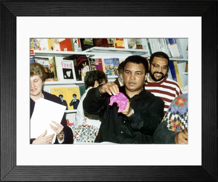 Framed Print : Muhammad Ali (Cassius Clay) former boxing champion does tricks to entertain the crowd Framed Print : Muhammad Ali (Cassius Clay) former boxing champion does tricks to entertain the crowd