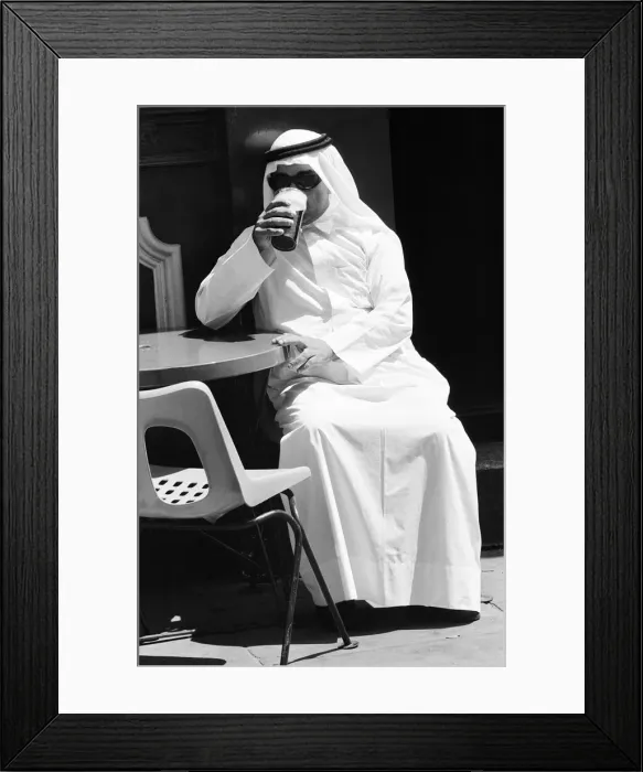 Framed Print : Arab man sitting outside enjoying a pint of Guinness at the Stanhope public house