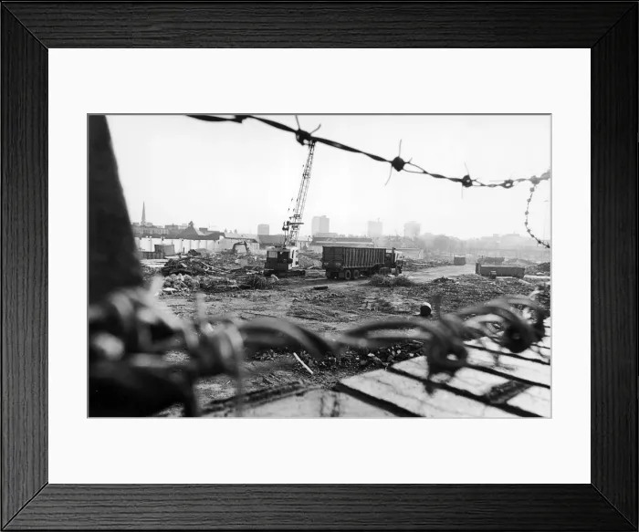 Framed Print : Lorries wait to take away the rubble which is all that remains of the former eight storey Framed Print : Lorries wait to take away the rubble which is all that remains of the former eight storey