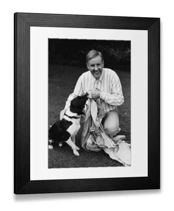 Framed Print : Actor Richard Briers seen here in the back garden of his West London home with his dog