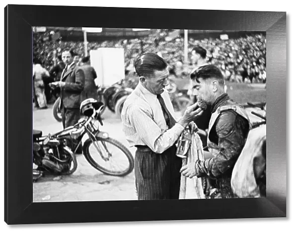 Dirt Track races in London. (Picture shows) A competitor receiving treatment for an
