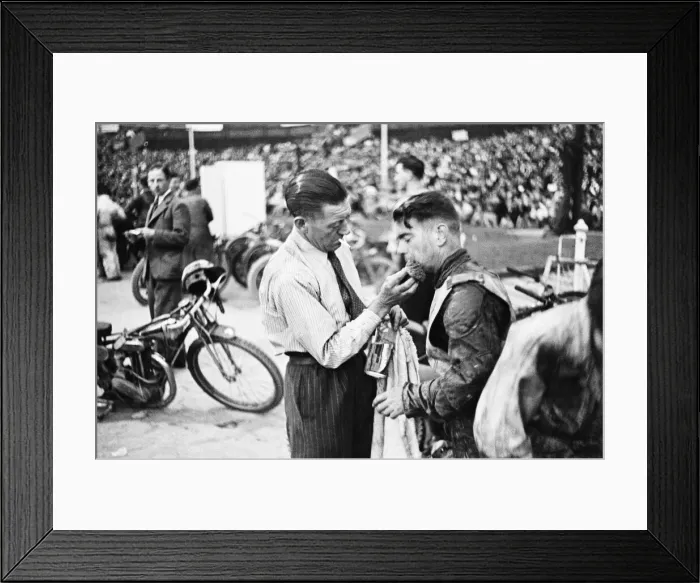Framed Print : Dirt Track races in London. (Picture shows) A competitor receiving treatment for an Framed Print : Dirt Track races in London. (Picture shows) A competitor receiving treatment for an
