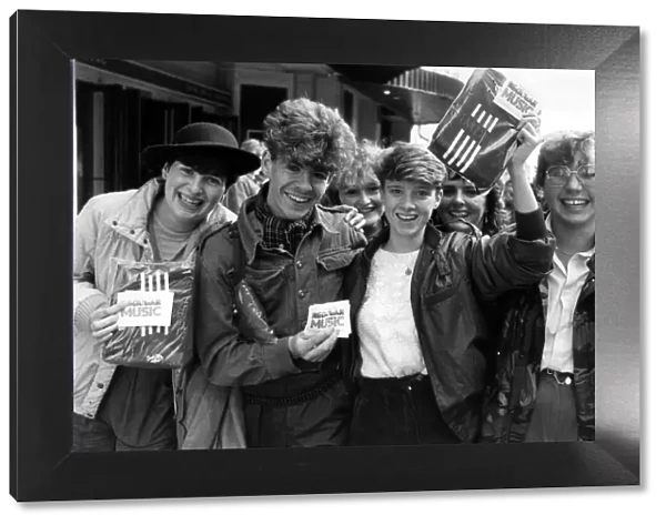 Fans of Simple Minds, Rock Group, celebrate after managing to purchase tickets for their