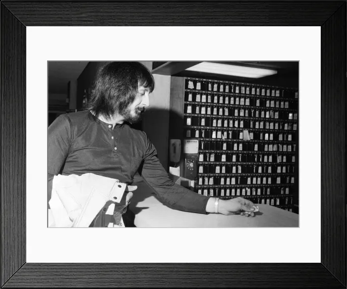 Framed Print : Members of The Who rock group. Bass guitarist John Entwistle hands in his hotel key Framed Print : Members of The Who rock group. Bass guitarist John Entwistle hands in his hotel key
