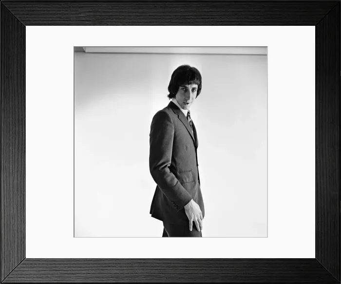 Framed Print : Pete Townshend of British rock group The Who, poses in the studio wearing suit and tie Framed Print : Pete Townshend of British rock group The Who, poses in the studio wearing suit and tie