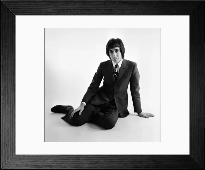 Framed Print : Pete Townshend of British rock group The Who, poses in the studio wearing suit and tie