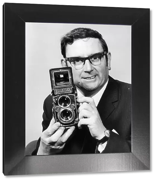 Charles Ley Daily Mirror Staff Photographer seen here with his trusty Rolleiflex camera