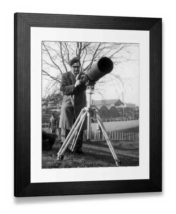 Framed Print : Daily Mirror Photographer Charles Ley seen here with a telephoto lens attached to his Framed Print : Daily Mirror Photographer Charles Ley seen here with a telephoto lens attached to his