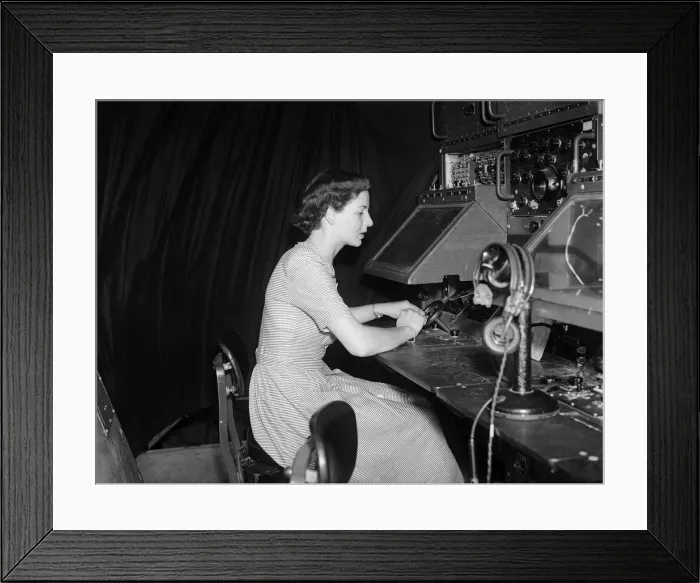 Framed Print : Topsy Watts, radar tracker at London Airport sits before apparatus with which she has