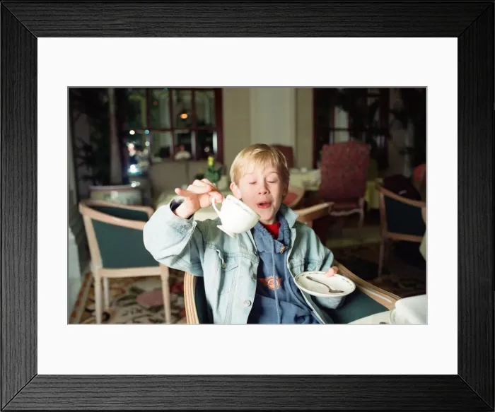 Framed Print : Macaulay Culkin sips his tea as he toasts his membership of he million-dollar-a movie