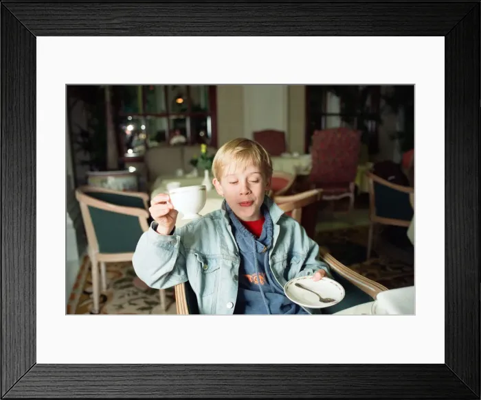 Framed Print : Macaulay Culkin sips his tea as he toasts his membership of he million-dollar-a movie