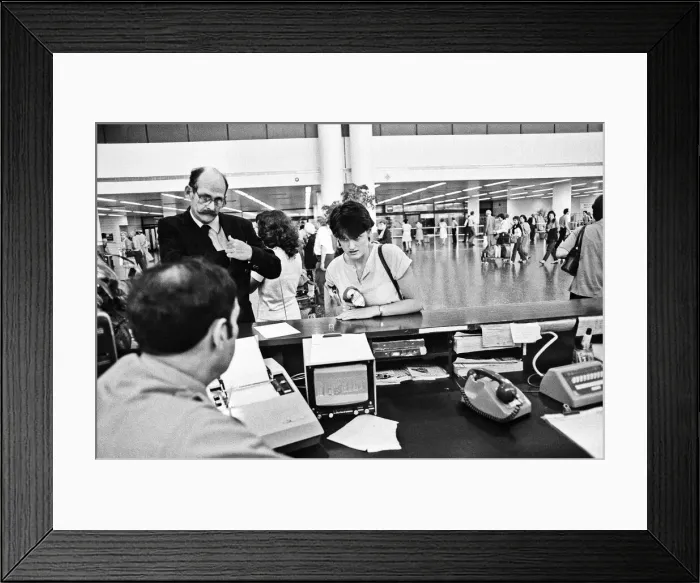 Framed Print : Passengers booking in their luggage at Gatwick Airport. 21st June 1983 Framed Print : Passengers booking in their luggage at Gatwick Airport. 21st June 1983