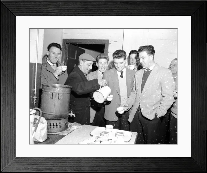 Framed Print : Cardiff City footballer Colin Baker is poured a cup of tea by the groundsman following a Framed Print : Cardiff City footballer Colin Baker is poured a cup of tea by the groundsman following a