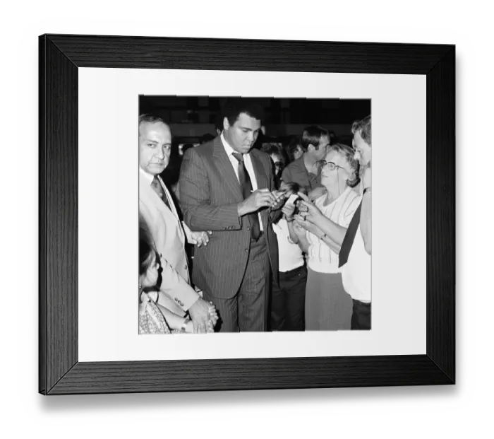 Framed Print : Muhammad Ali signing autographs for fans in England before his journey back to Chicago Framed Print : Muhammad Ali signing autographs for fans in England before his journey back to Chicago