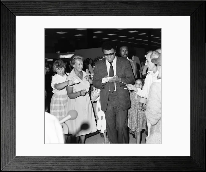 Framed Print : Muhammad Ali signing autographs for fans in England before his journey back to Chicago Framed Print : Muhammad Ali signing autographs for fans in England before his journey back to Chicago