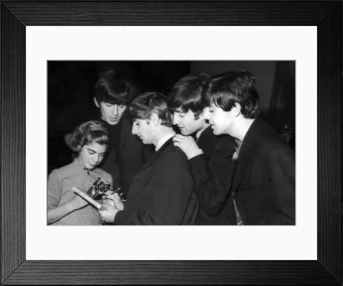 Framed Print : The Beatles sign autographs for a young fan after concert at the Odeon in Southend-on-Sea