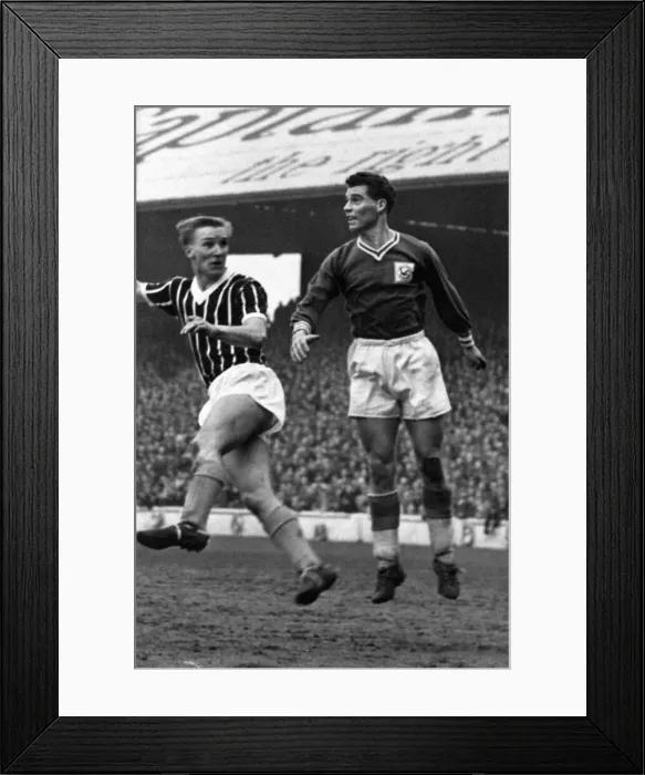 Framed Print : Colin Baker of Cardiff City leaps to clear the ball during a League Division One match Framed Print : Colin Baker of Cardiff City leaps to clear the ball during a League Division One match