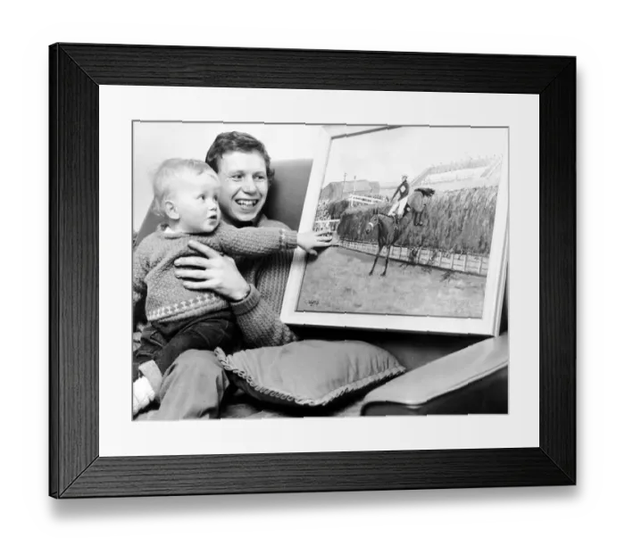 Framed Print : Jockey Brian Fletcher pictured showing his son Andrew a painting of Red Rum landing over