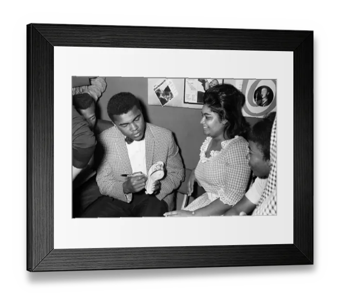 Framed Print : Cassius Clay aka (Muhammad Ali) signs his autograph on a slipper for a fan in London
