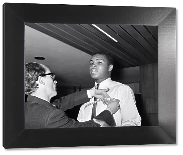 Cassius Clay aka (Muhammad Ali) getting measured at Austin Reeds in London